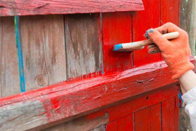 A Painter Painting Wooden Fence