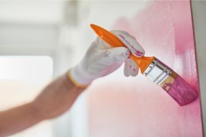 Interior Painter painting a wall pink