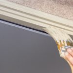 Professional exterior painter with brush