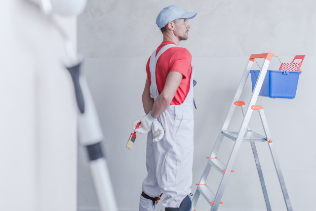 Room Painter with ladder and paint bucket and paint brush